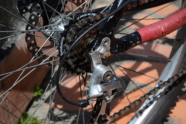 Two paddleboarders silhouetted against a glowing desert sunset, standing calmly on still water beneath dramatic clouds.