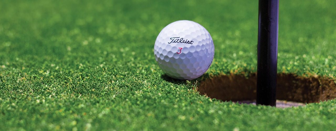 Golf ball resting near the cup on a scenic desert course near Moab, Utah.