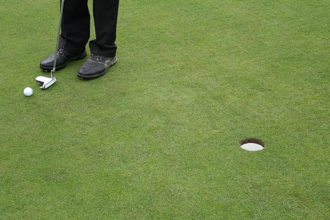 Golfer putting on a green at a desert golf course near Moab, Utah.