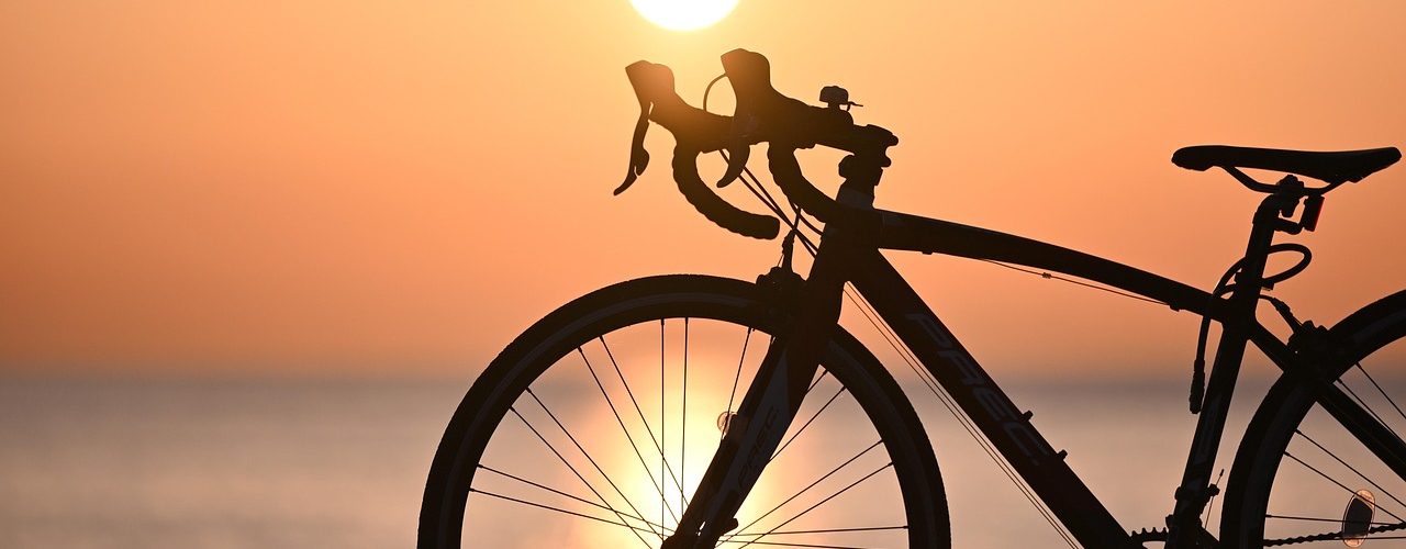 Silhouette of a road bike at sunrise over the Colorado River near Moab, Utah.