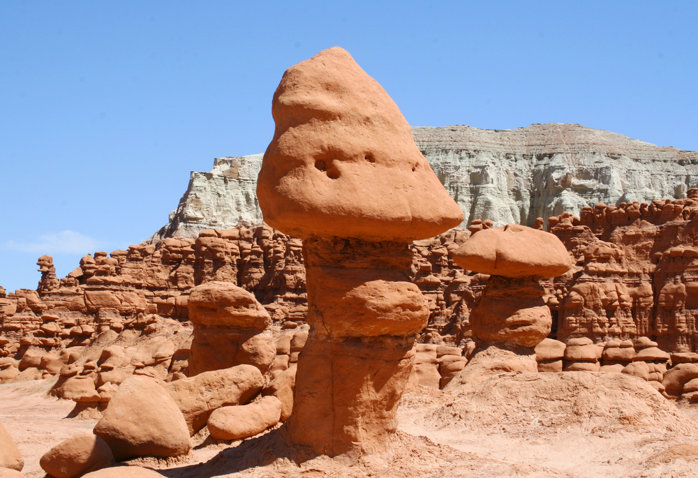 Mushroom-shaped sandstone hoodoos rise from the desert floor at Goblin Valley State Park, Utah.